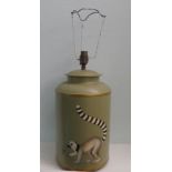 A mid 20thC tin plate table lamp, decorated with a lemur  13"h