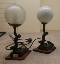 A pair of modern Art Deco design resin table lamps, each fashioned as a kneeling female figure,