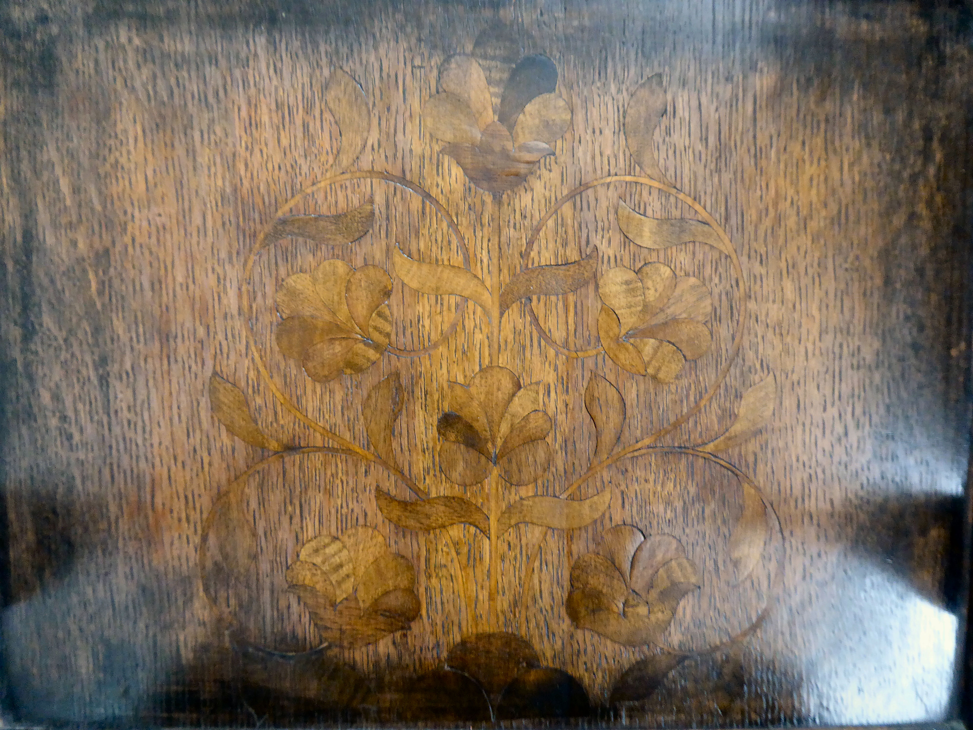 An antique finished, dark stained oak floral marquetry, panelled back, low, open arm chair with a - Image 5 of 5