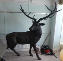 A cast bronze model, a stag with removable horns 88"h with provision in the hooves to be fixed to