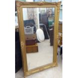 A modern mirror, the plate set in a moulded gilded pine frame  29" x 48"