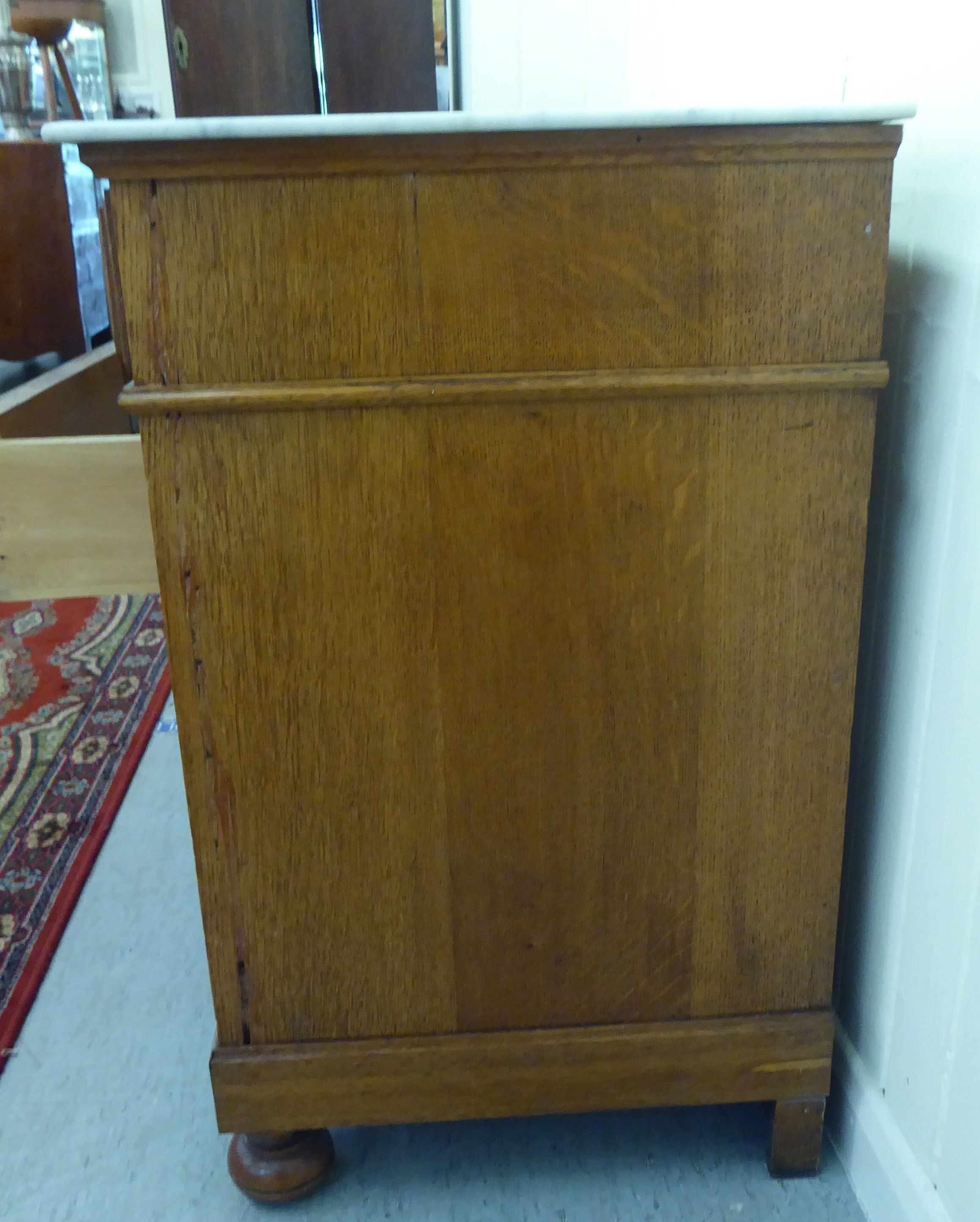 An early/mid 20thC oak commode, the fixed grey/white marble top, over two short/three long - Image 6 of 6