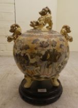 An early 20thC Japanese Satsuma earthenware vase of spherical form, surmounted by dragons, decorated