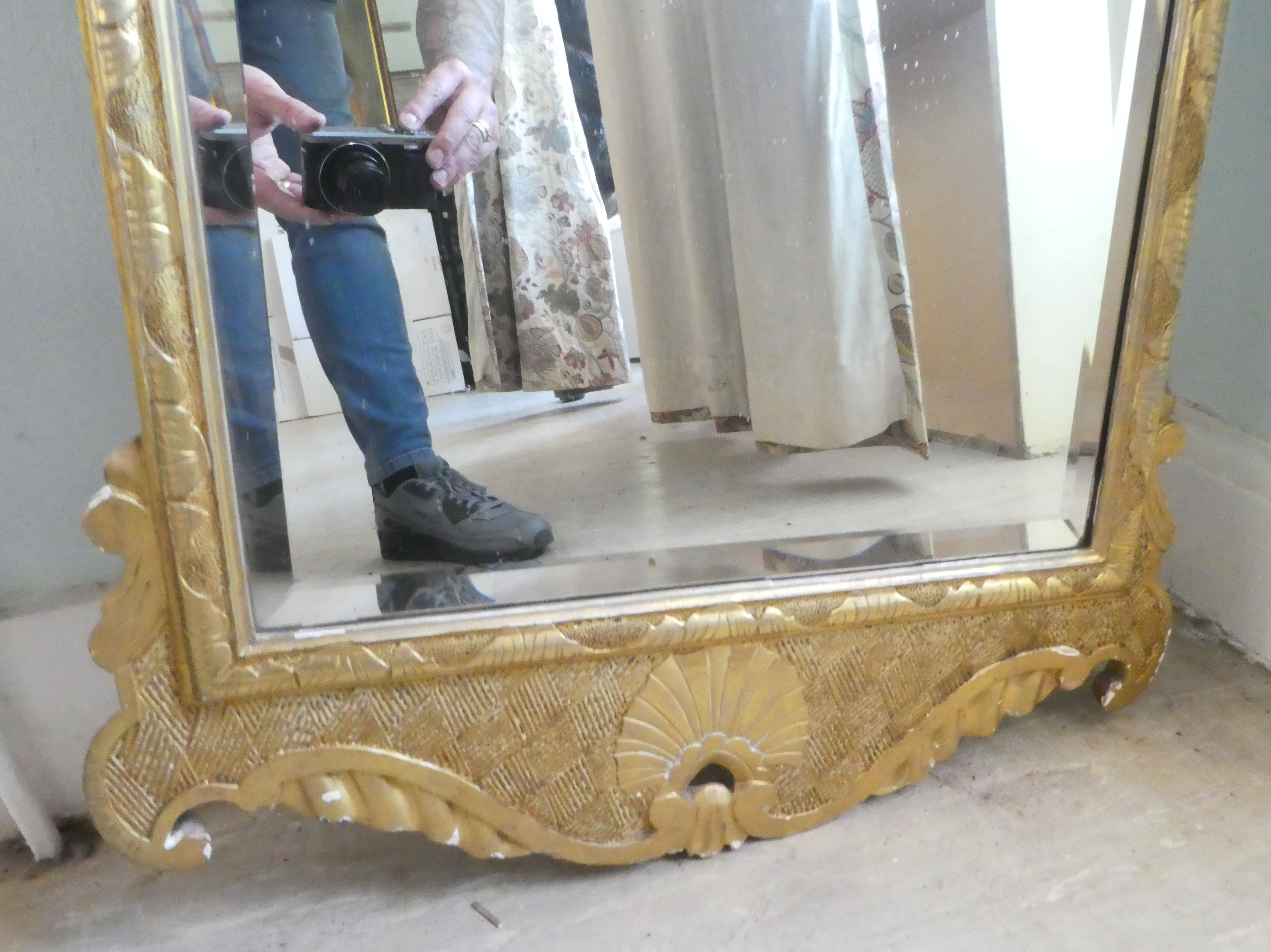 An early 20thC mirror, the shaped, bevelled plate set in a gilded pine frame  44" x 24" - Image 2 of 5