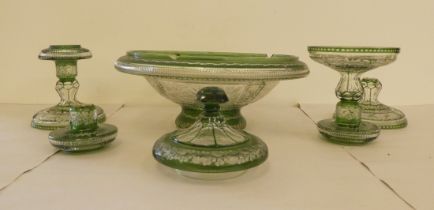 Matched, tinted green engraved cut glass  comprising a pair of candlesticks  5"h; a bowl  12"dia;