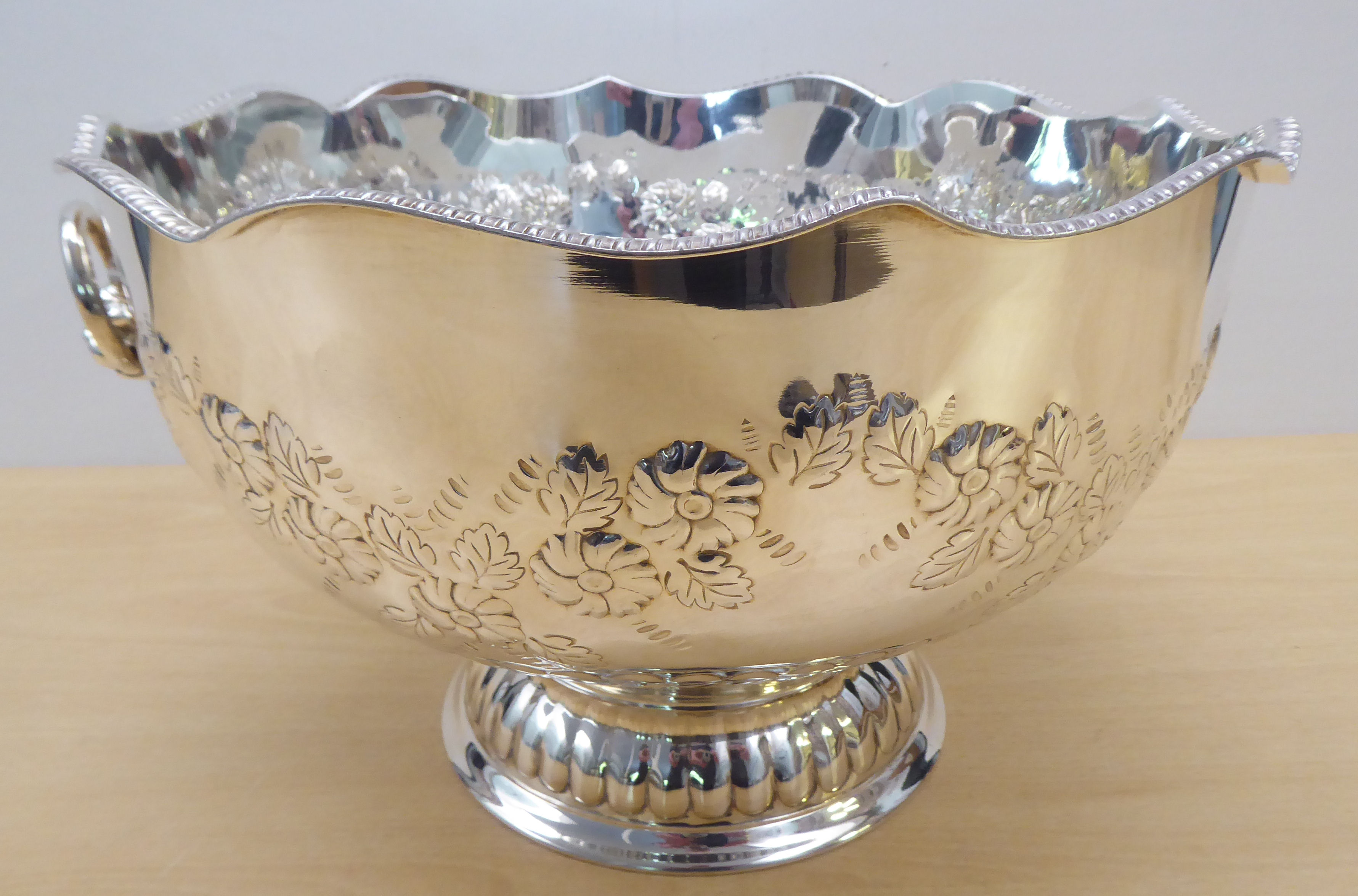 A Georgian design silver plated on copper pedestal punch bowl with opposing lion mask handles  8"