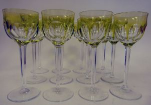 A set of twelve clear and tinted yellow glass pedestal wines