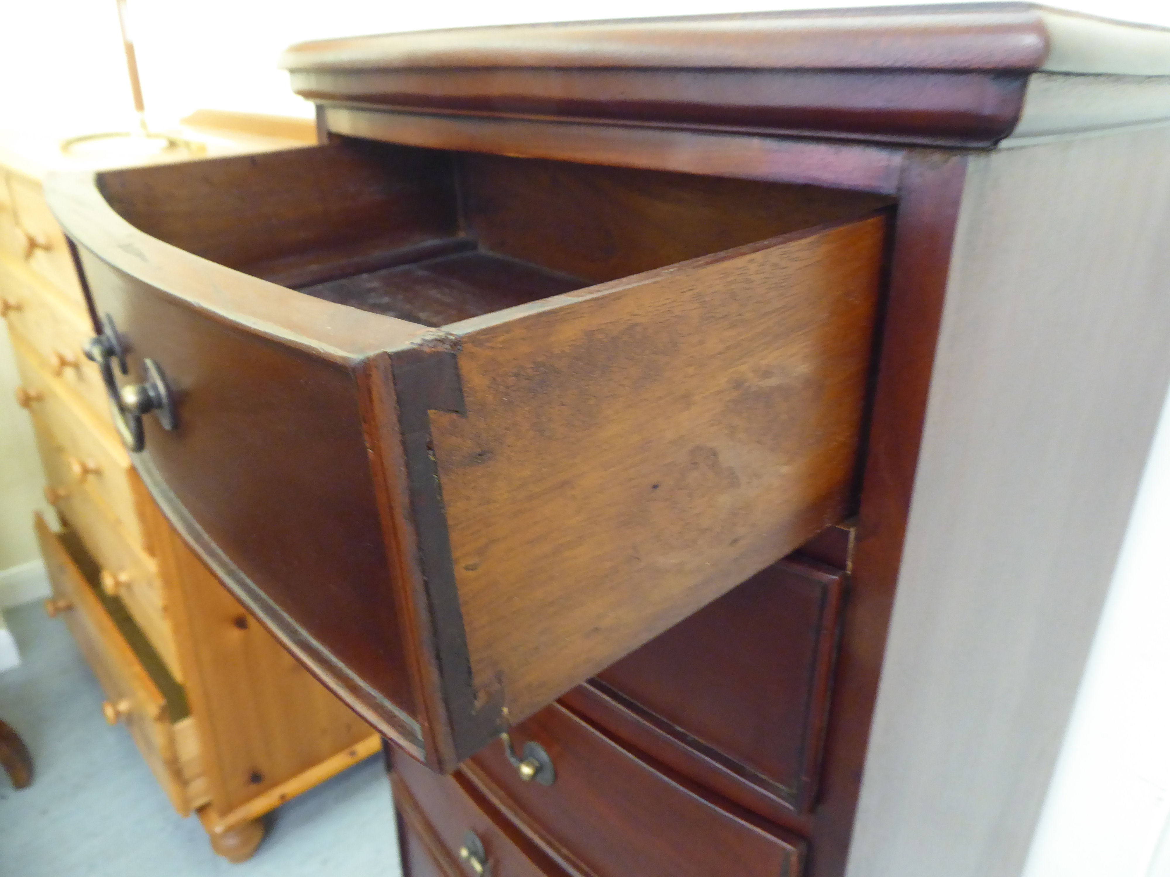 A modern mahogany bow front seven drawer tallboy, raised on bracket feet  47"h  20"w - Image 3 of 4