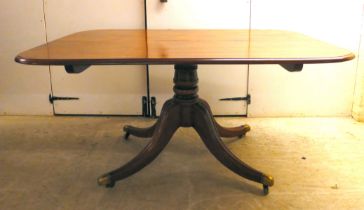 A Regency mahogany tip-top dining table, raised on turned, columns and four splayed legs with