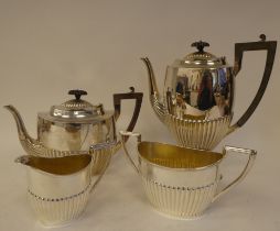 An Edwardian four piece silver tea set of oval demi-reeded form  comprising a teapot with a swept