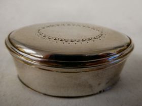 A George III silver, oval nutmeg grater, having straight sides and a hinged lid with simply engraved