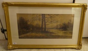 John Guttridge Sykes - a woodland riverscape  watercolour  bears a signature  12" x 23"  framed