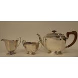 A three piece silver tea set of panelled elongated octagonal form  comprising a teapot with a