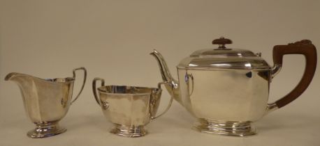 A three piece silver tea set of panelled elongated octagonal form  comprising a teapot with a