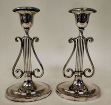 A pair of loaded silver lyre design candlesticks of oval outline, each with a detachable sconce