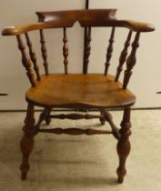 An early 20thC beech and elm framed captain's design desk chair, the solid seat raised on turned