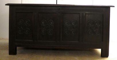 A late 18thC carved oak coffer with straight sides and a hinged lid, raised on block feet  29"h