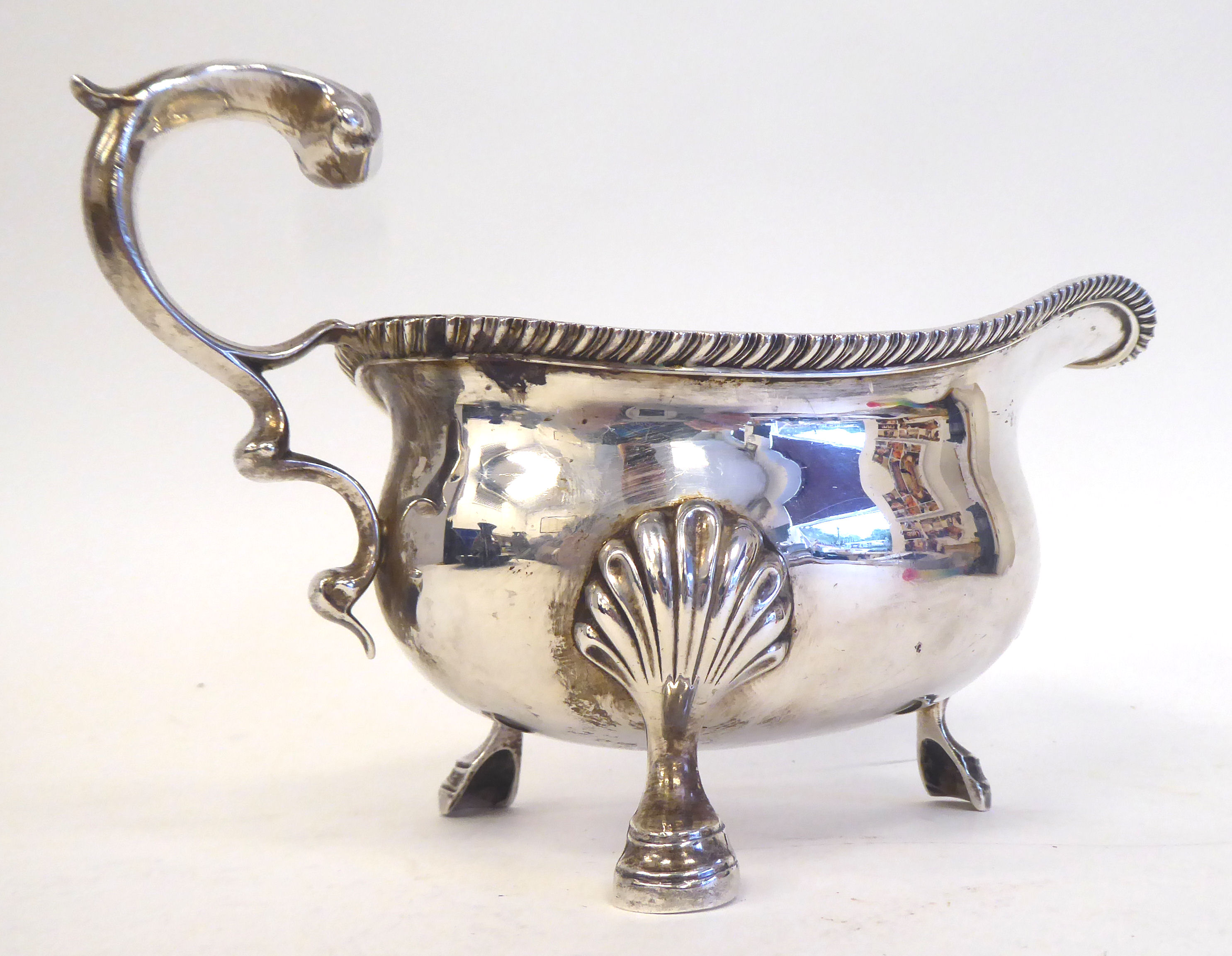 An Edwardian silver sauce boat with a gadrooned border and double S-scrolled handle, elevated on - Image 5 of 5