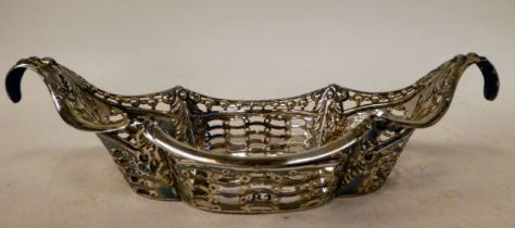 A late Victorian silver oval bread basket with decoratively pierced and embossed sides  James