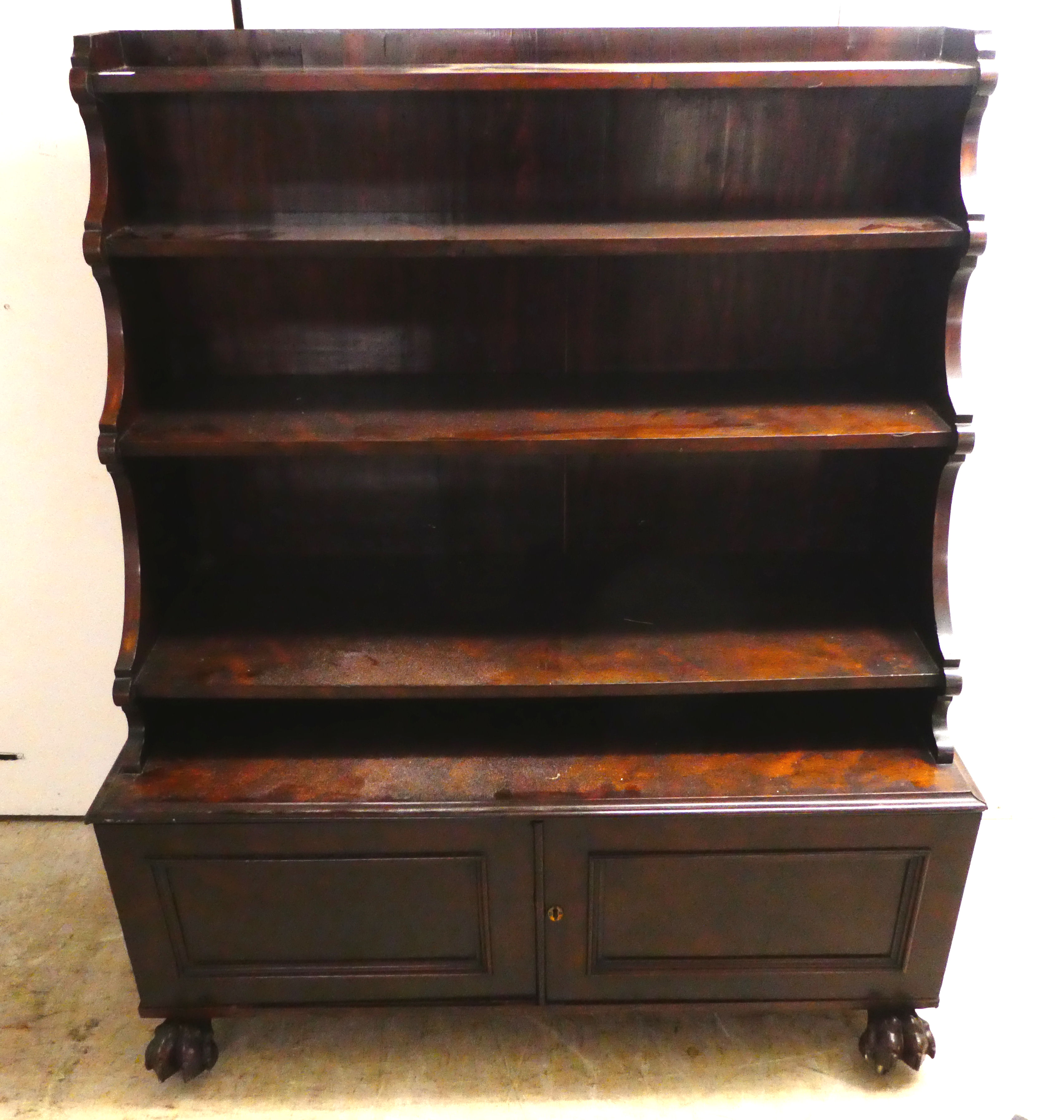 An early 19thC mahogany waterfall front bookcase with three tiers, over two panelled doors, on a - Image 2 of 4