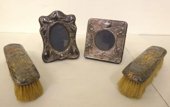 A pair of Art Nouveau silver backed clothes brushes, decorated with standing female figures; and two