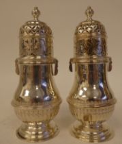 A pair of silver pedestal vase design casters, having decoratively pressed, pierced and engraved