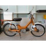 A 1975 Honda 49cc moped in orange and white livery, original registration plates for JGS 258N but no