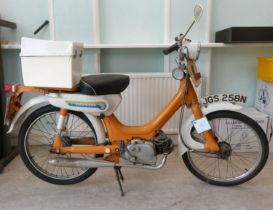 A 1975 Honda 49cc moped in orange and white livery, original registration plates for JGS 258N but no