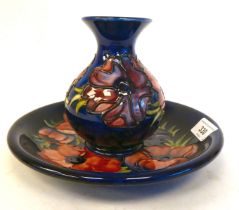 A Moorcroft pottery plate, decorated in tubeline in the Anenome pattern  bears an impressed mark and