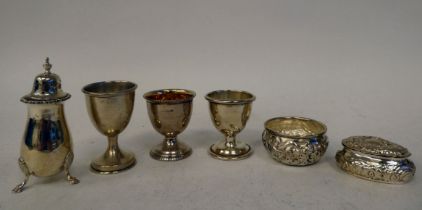 Silver silver items, viz. three pedestal egg cups; a pin bowl; a patch box; and a pepper pot