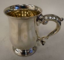 A George VI silver one pint mug of baluster form with an applied wire rim, stepped footrim and