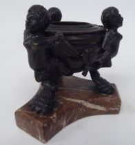 A late 19thC cast and patinated bronze censer, supported by three winged, cherubic figures, on a