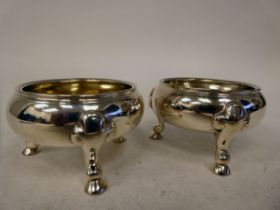 A pair of late 18thC silver salt cellars of shallow, squat, bulbous form with applied wire rims,