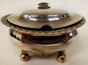 A George III silver oval mustard pot with egg and dart border decoration, the hinged lid elevated on