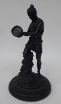 A late 19thC cast and patinated bronze figure, an African native figure with a tambourine  11"h