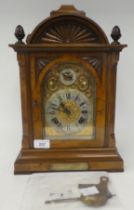 A late 19thC walnut cased bracket clock, having an arched pediment, finials and fretworked flanks,