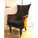 A William IV mahogany showwood framed library chair with a lyre shaped front, later upholstered in