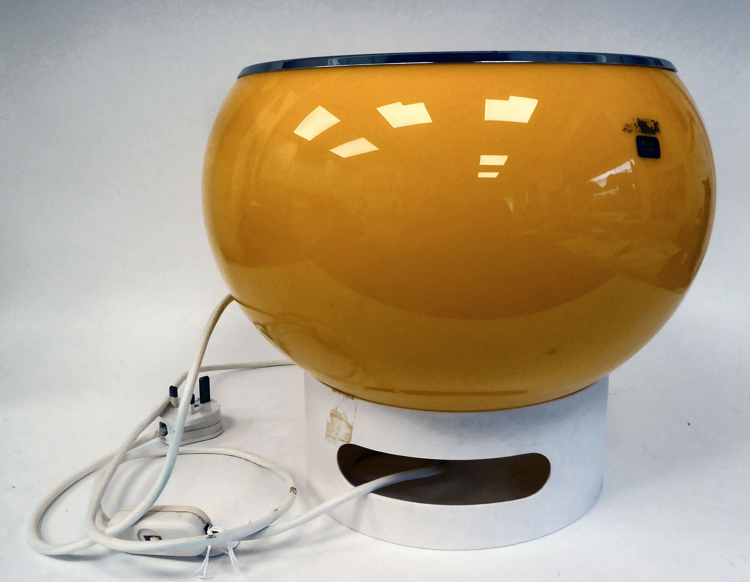 A vintage 1970s 'Glan' Harvey Guzzini lamp, in yellow and white with a chromium plated rim  12"h