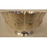 A Victorian silver footed bowl with multi-panelled sides and a wavy rim, decorated in embossed and