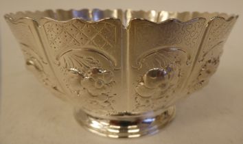 A Victorian silver footed bowl with multi-panelled sides and a wavy rim, decorated in embossed and