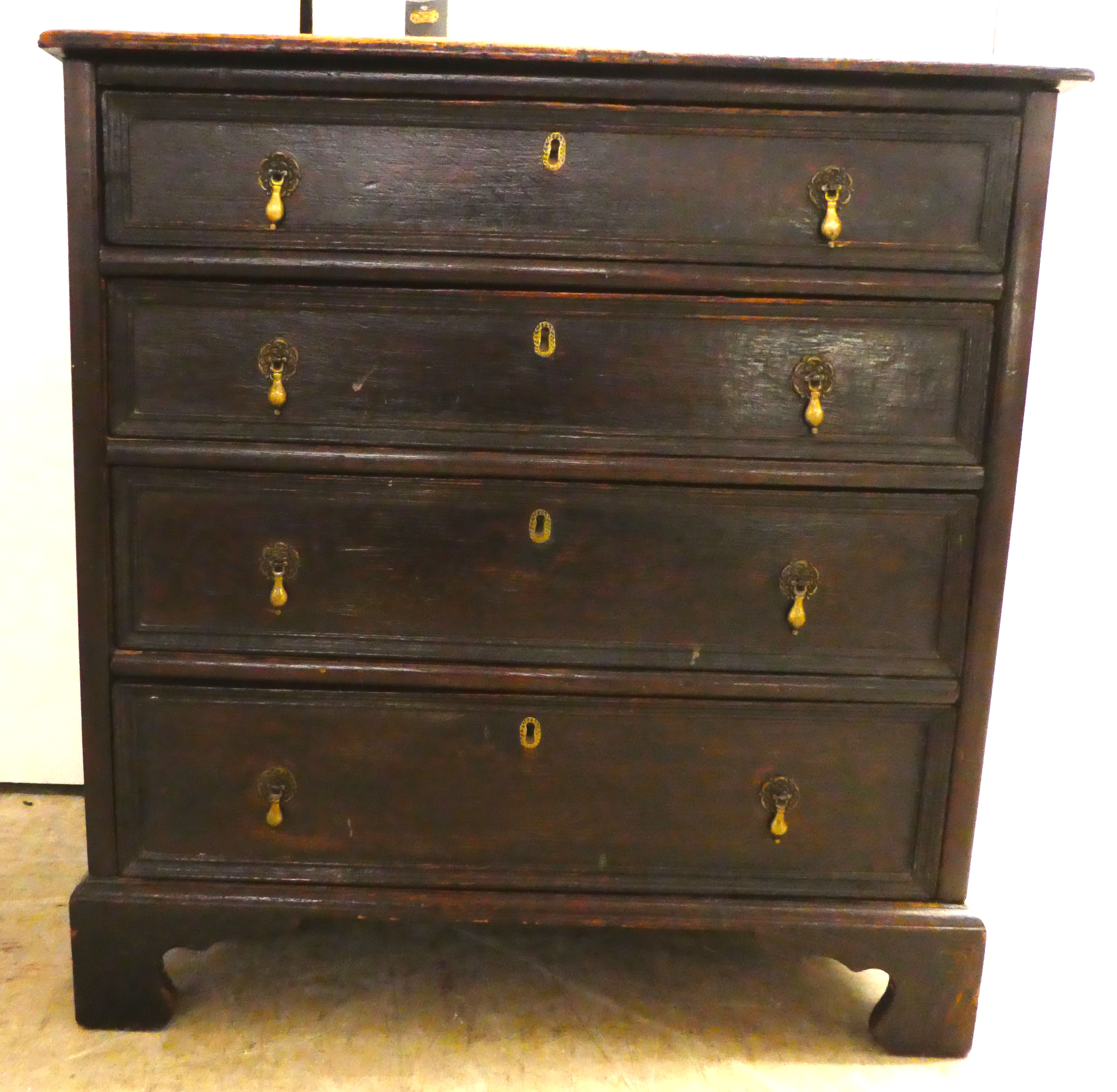 An early 19thC stained oak dressing chest with graduated four drawers, raised on bracket feet  31"h