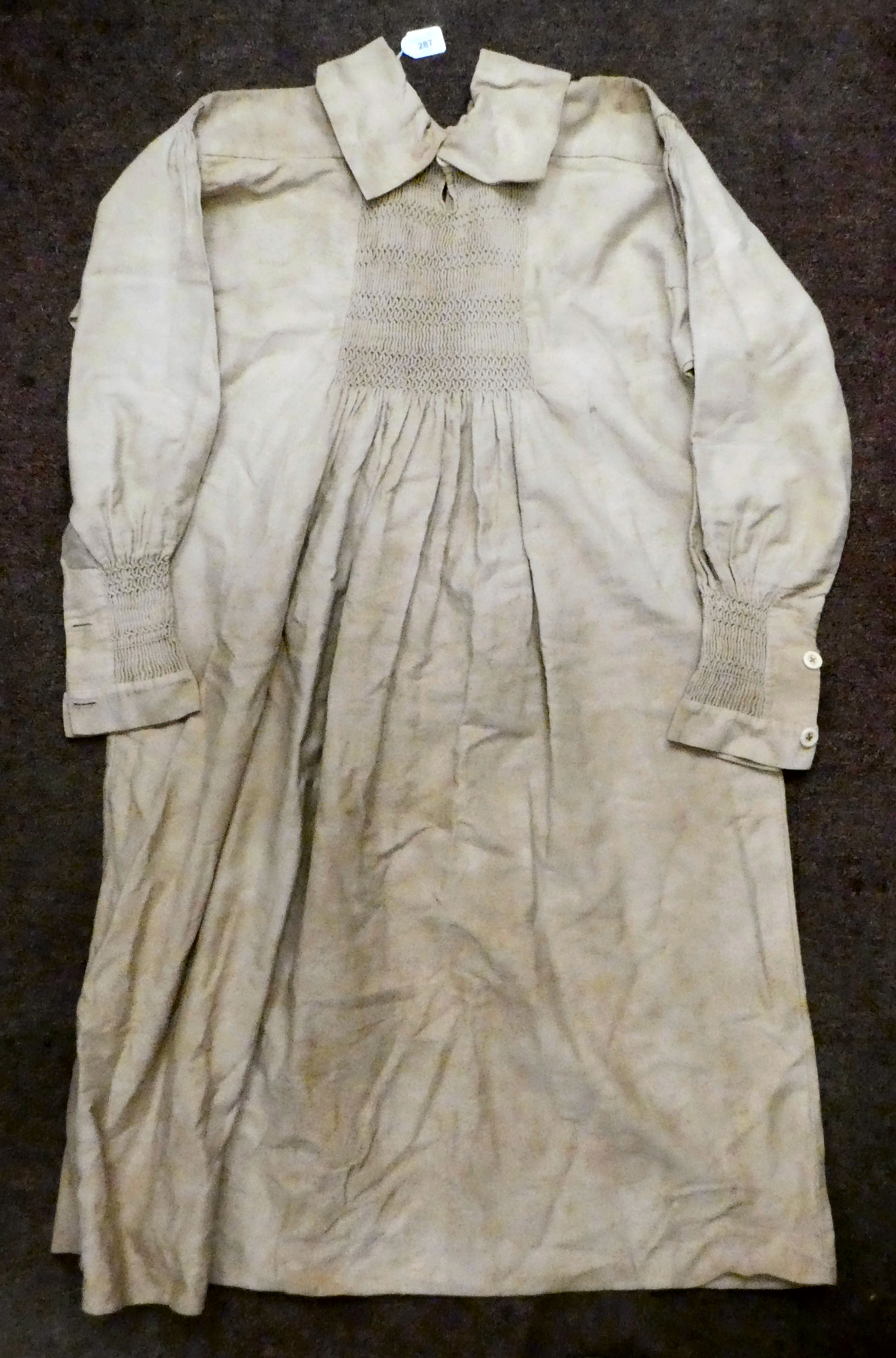 A Continental artisan's brown pleated calico dress with decorative smocking