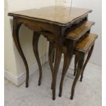 A nesting set of three early 20thC beech and marquetry inlaid tables, raised on cabriole legs