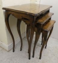A nesting set of three early 20thC beech and marquetry inlaid tables, raised on cabriole legs