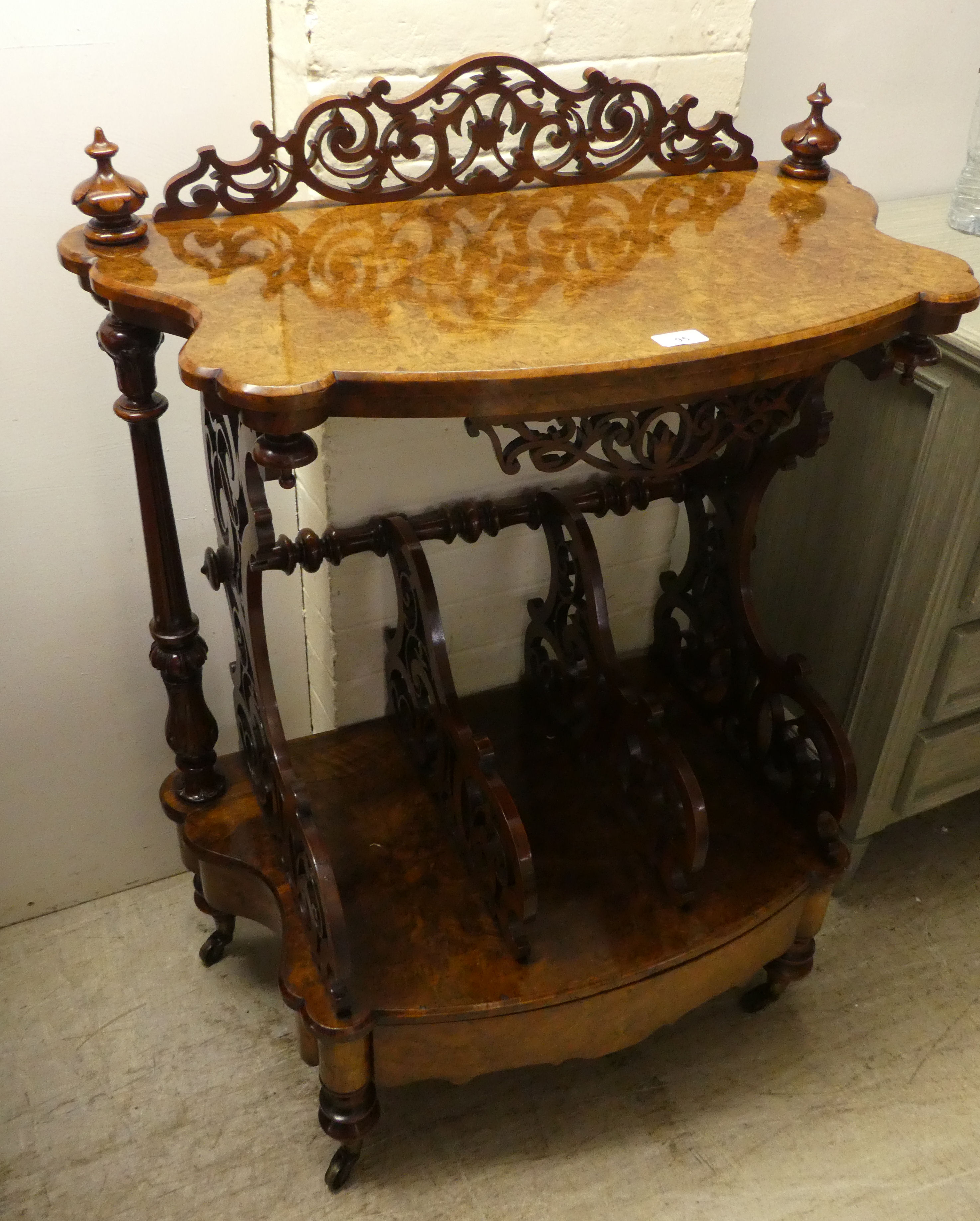 A late Victorian walnut what-not Canterbury with a pierced gallery, over three divided sections