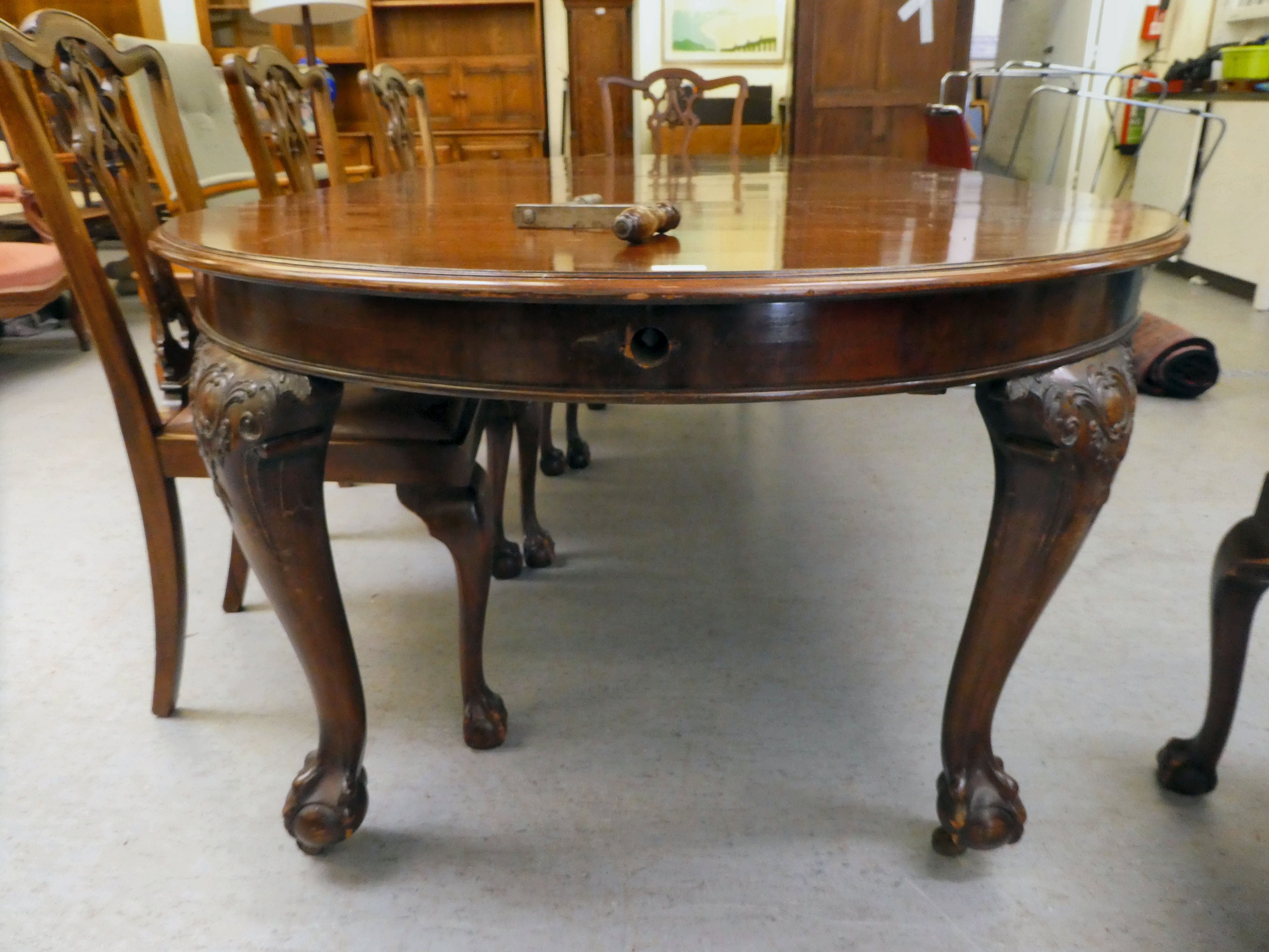 A 1920s mahogany wind-out dining table, raised on cabriole legs, talon and ball feet  29"h  46"L - Image 3 of 5