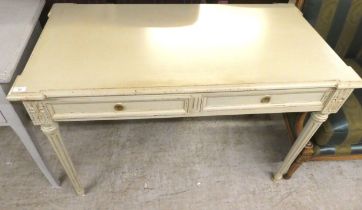 A modern cream painted, distressed oak desk with two drawers, raised on turned, fluted legs  30"h