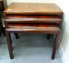 A nesting set of three modern rosewood finished occasional tables with panelled tops, raised on