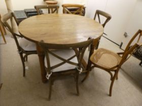A modern light oak dining table, raised on turned legs  30"h  50"dia; and a matching set of six