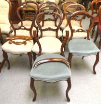 A matched set of ten late Victorian carved mahogany framed balloon back dining chairs with